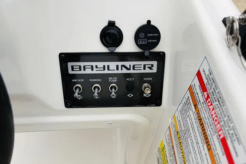 Slide: The Image of Control panel of 2023 Bayliner Element M15 boat with switches and warnings. - 25