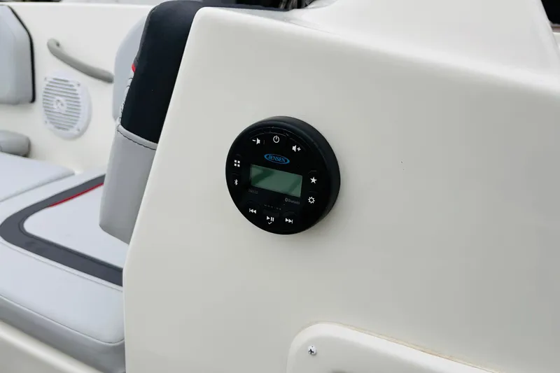 Slide: The Image of 2023 Bayliner Element M15 boat interior with audio control panel and speaker. - 26