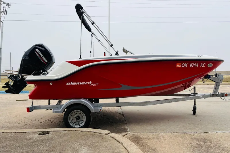 Slide: The Image of 2023 Bayliner Element M15 boat in red on a trailer, side view. - 7