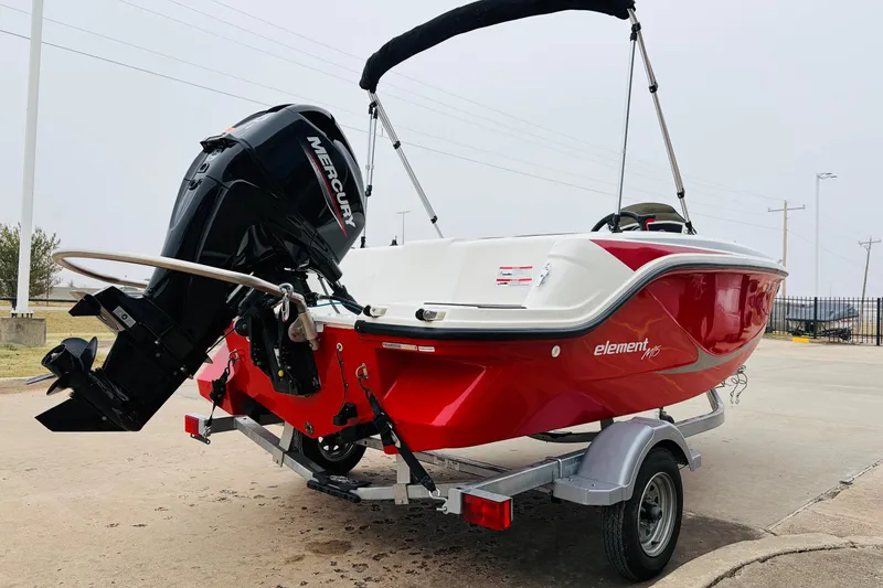 Slide: The Image of 2023 Bayliner Element M15 boat with Mercury engine on trailer, red and white design. - 8