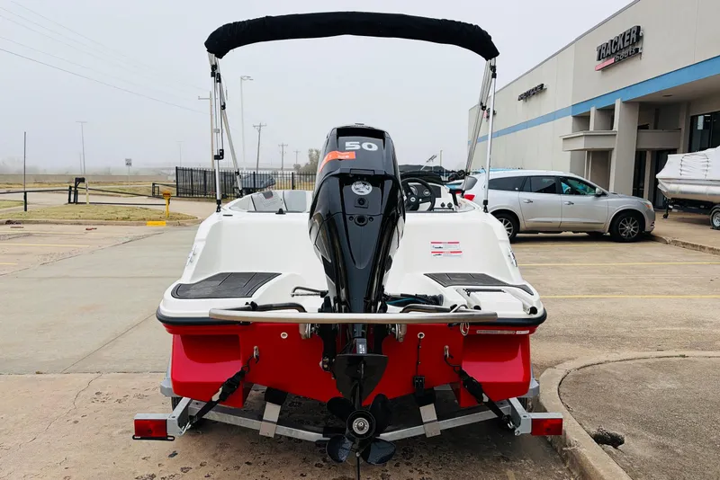 Slide: The Image of 2023 Bayliner Element M15 boat with outboard motor, parked outside dealership. - 9