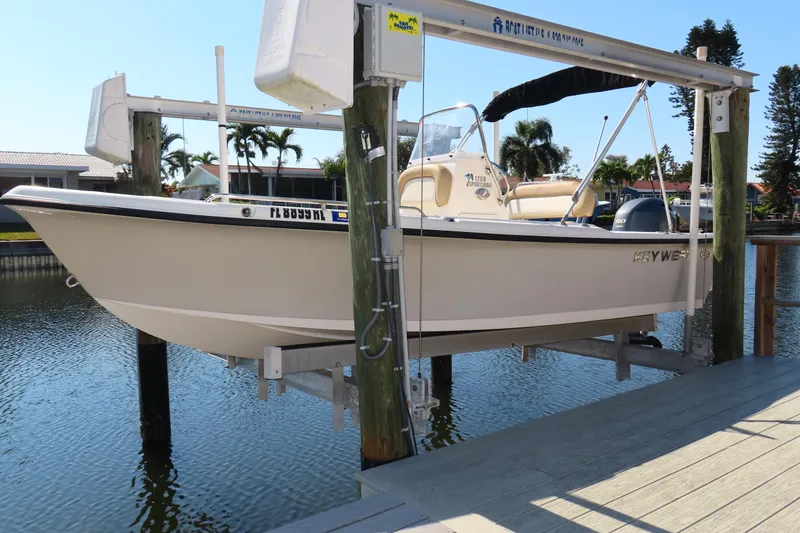 The Image of 2018 Key West 1720 Center Console boat on lift by waterfront dock. - 0