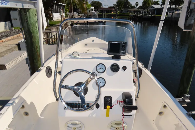 Slide: The Image of 2018 Key West 1720 Center Console boat dashboard with steering wheel and navigation equipment. - 10
