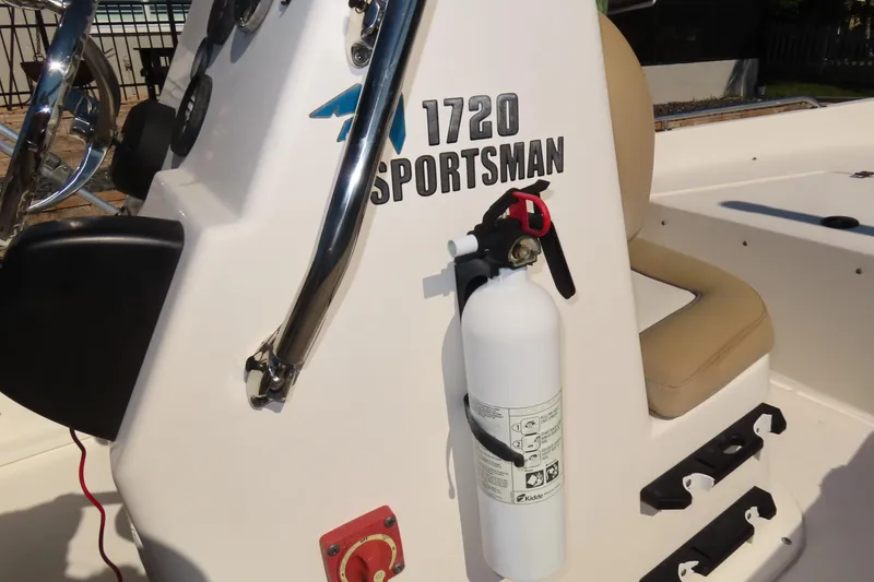 Slide: The Image of 2018 Key West 1720 Center Console boat with fire extinguisher and beige seating. - 12