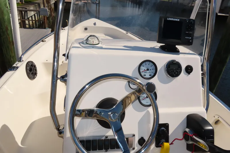 Slide: The Image of 2018 Key West 1720 Center Console boat dashboard with steering wheel and navigation equipment. - 17