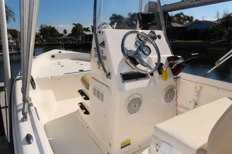 Slide: The Image of 2018 Key West 1720 Center Console boat interior with steering wheel and seating. - 2