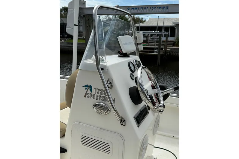 Slide: The Image of 2018 Key West 1720 Center Console boat with steering wheel and control panel. - 6