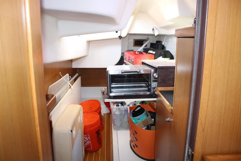 Slide: The Image of Interior of 2011 Catalina 445 sailboat with storage and kitchen appliances. - 15