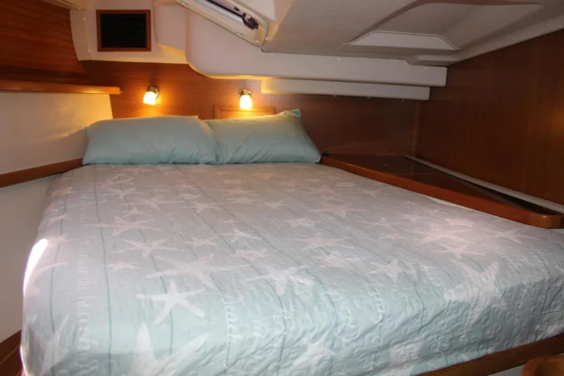 Slide: The Image of Cozy cabin interior of 2011 Catalina 445 sailboat with star-patterned bedding. - 16