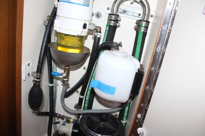 Slide: The Image of Engine compartment of a 2011 Catalina 445 sailboat, showing fuel and fluid systems. - 21