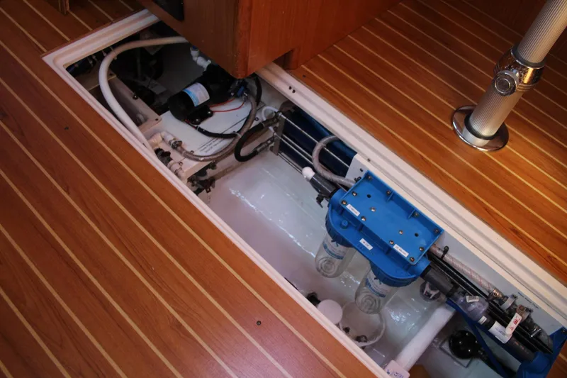 Slide: The Image of 2011 Catalina 445 yacht interior showing engine compartment and wooden flooring. - 23
