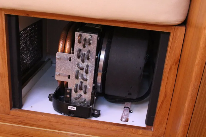 Slide: The Image of 2011 Catalina 445 interior component, featuring a compact mechanical system with copper coils. - 24