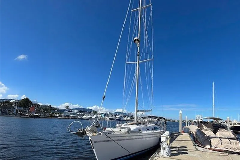 Slide: The Image of 2011 Catalina 445 sailboat docked at marina under clear blue sky. - 27