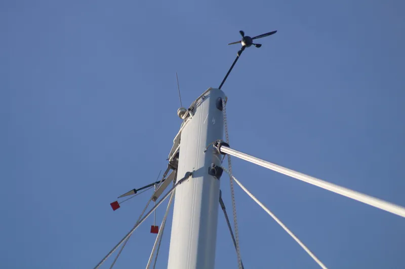 Slide: The Image of Mast of 2011 Catalina 445 sailboat with wind vane against clear blue sky. - 32