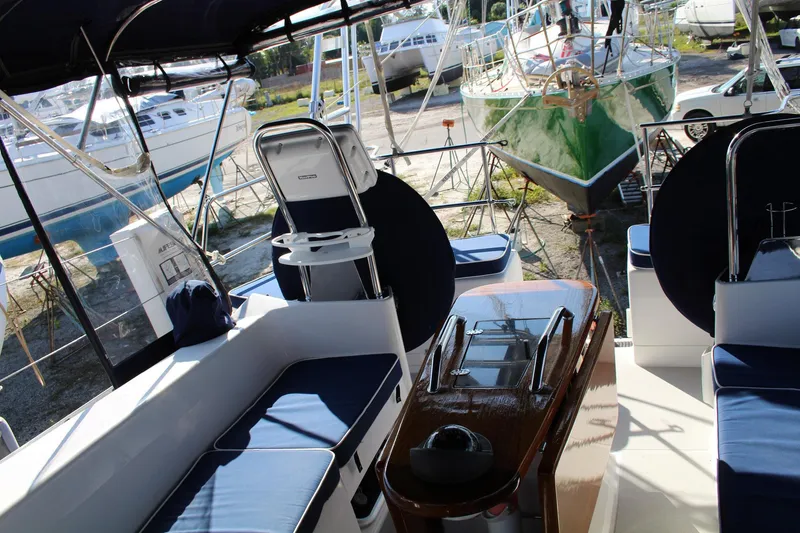 Slide: The Image of Interior view of a 2011 Catalina 445 sailboat with blue seating and wooden table. - 39