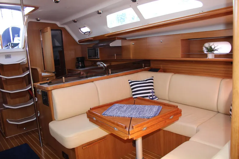Slide: The Image of Luxurious interior of 2011 Catalina 445 sailboat with cozy seating and elegant wood finish. - 4
