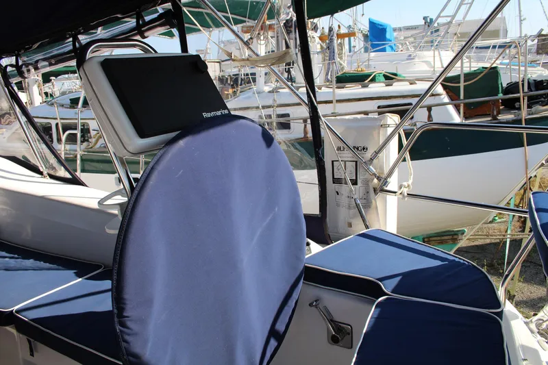 Slide: The Image of 2011 Catalina 445 sailboat cockpit with blue cushions and Raymarine navigation system. - 41
