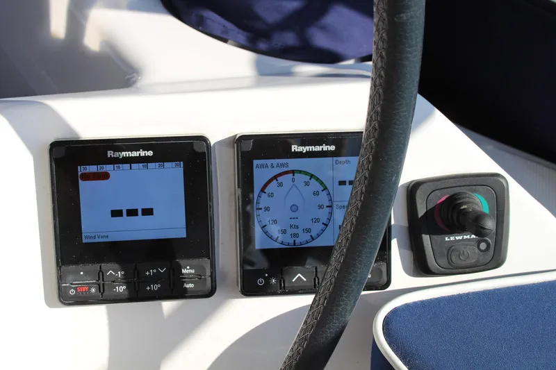 Slide: The Image of Raymarine navigation instruments on a 2011 Catalina 445 sailboat dashboard. - 44
