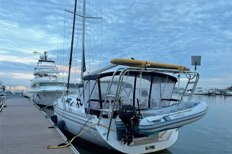 Slide: The Image of 2011 Catalina 445 sailboat docked at marina under cloudy sky. - 48