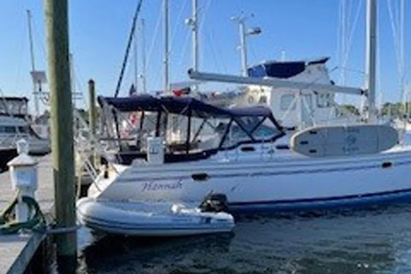 Slide: The Image of 2011 Catalina 445 sailboat docked with paddleboard and dinghy. - 49