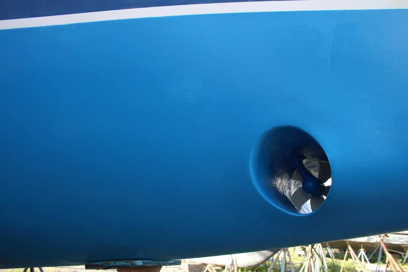 Slide: The Image of Blue hull of 2011 Catalina 445 sailboat with visible bow thruster. - 52