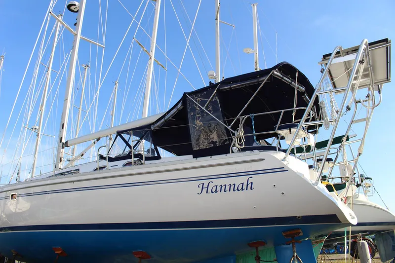 Slide: The Image of 2011 Catalina 445 sailboat named "Hannah" docked, featuring sleek design and blue accents. - 55