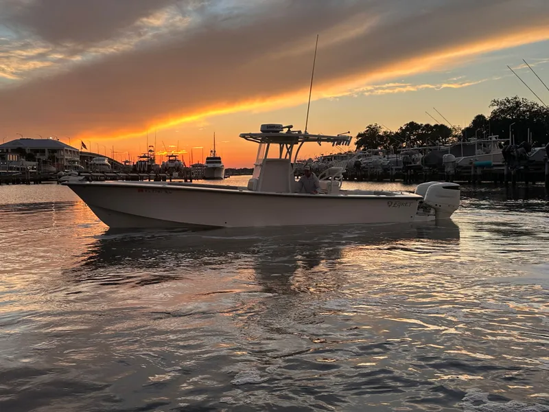 The Image of A 2019 Egret 290 boat cruises on calm water at sunset. The sky is dramatically colored. - 0