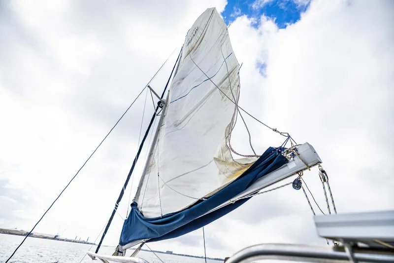 Slide: The Image of Sail of a 2014 Gemini Legacy 35 yacht against a cloudy sky. - 11