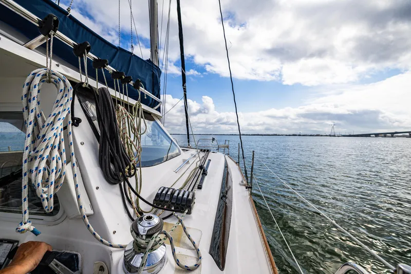 Slide: The Image of Sailing on a 2014 Gemini Legacy 35 catamaran, ropes and winch visible, under a partly cloudy sky. - 14