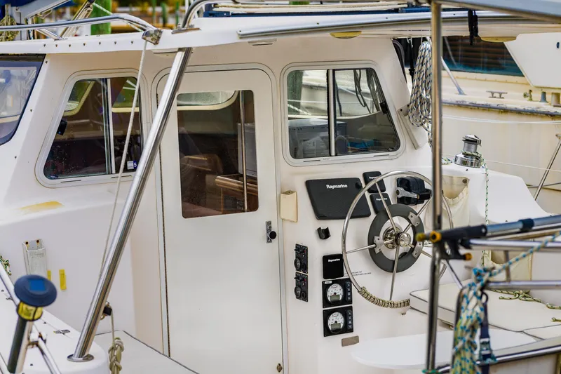 Slide: The Image of Cockpit of 2014 Gemini Legacy 35 sailboat with steering wheel and navigation instruments. - 15