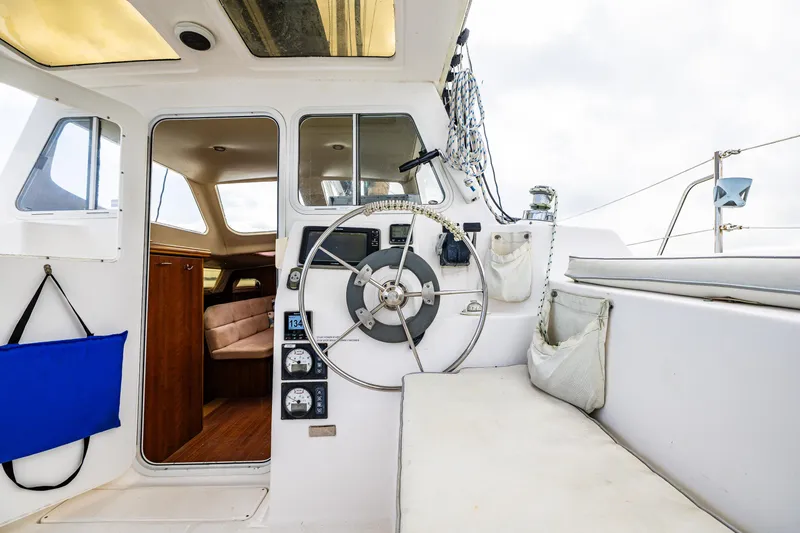 Slide: The Image of Interior view of 2014 Gemini Legacy 35 sailboat cockpit with steering wheel and seating. - 16