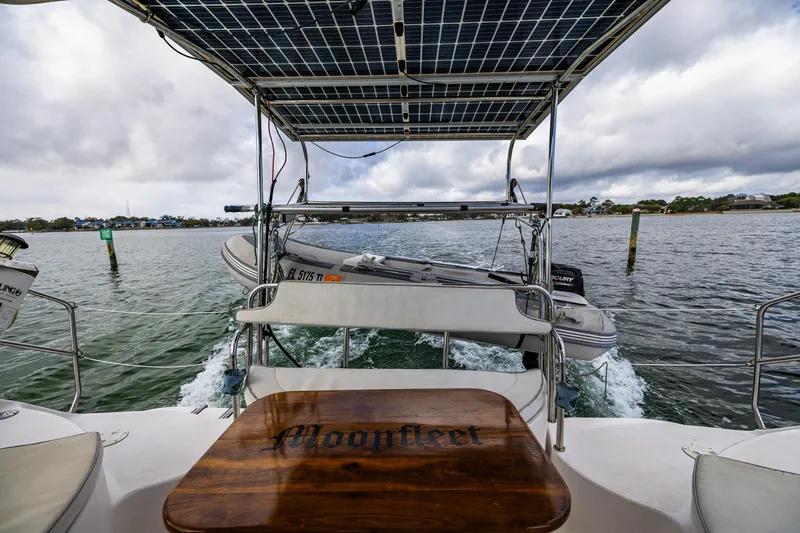 Slide: The Image of Gemini Legacy 35 sailboat with solar panels and dinghy on water, 2014 model. - 20