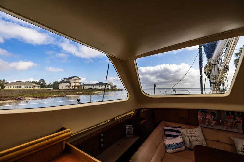 Slide: The Image of Interior view from a 2014 Gemini Legacy 35 sailboat, showcasing a scenic waterfront. - 24