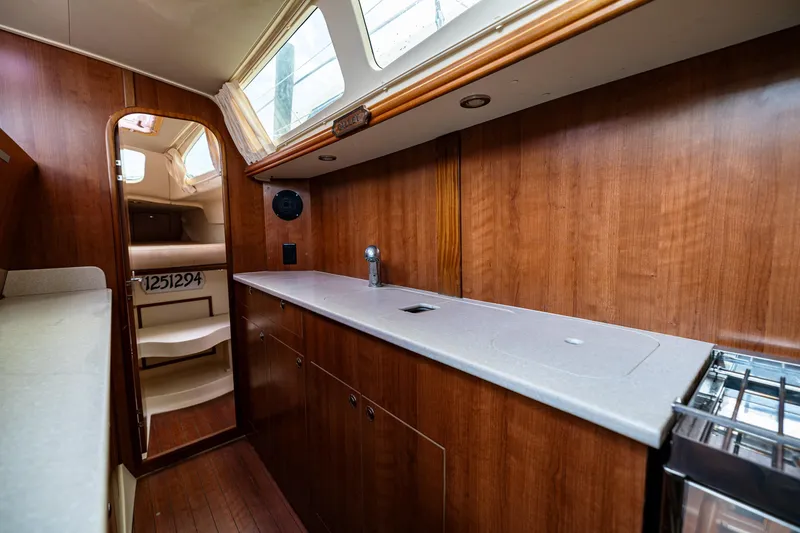 Slide: The Image of Interior of 2014 Gemini Legacy 35 sailboat with wood cabinetry and modern amenities. - 30