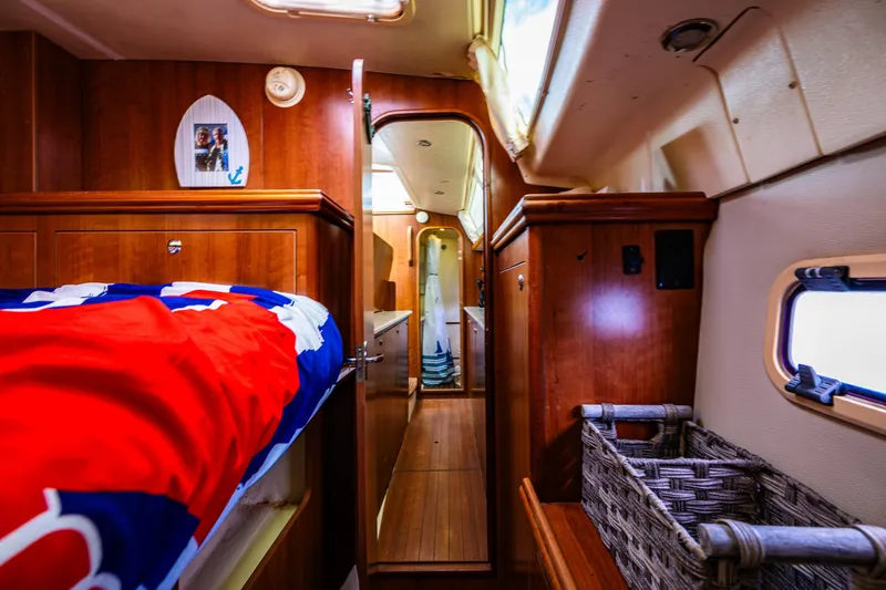 Slide: The Image of Interior of 2014 Gemini Legacy 35 sailboat with wooden cabinetry and cozy bedding. - 32