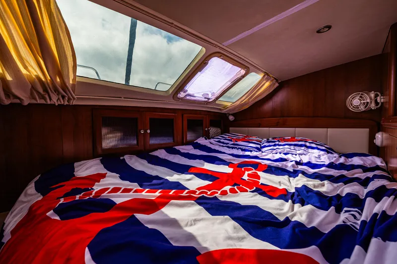 Slide: The Image of Cozy cabin interior of 2014 Gemini Legacy 35 sailboat with nautical-themed bedding. - 33