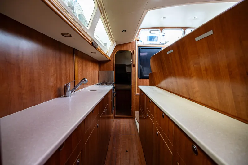 Slide: The Image of Interior of 2014 Gemini Legacy 35 yacht kitchen with wood cabinetry and countertops. - 36