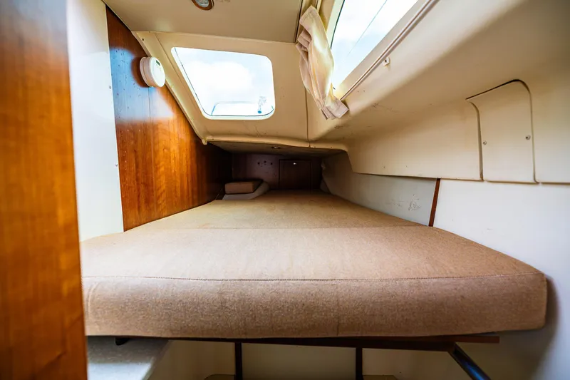 Slide: The Image of Cozy cabin interior of 2014 Gemini Legacy 35 sailboat with cushioned berth and window. - 37