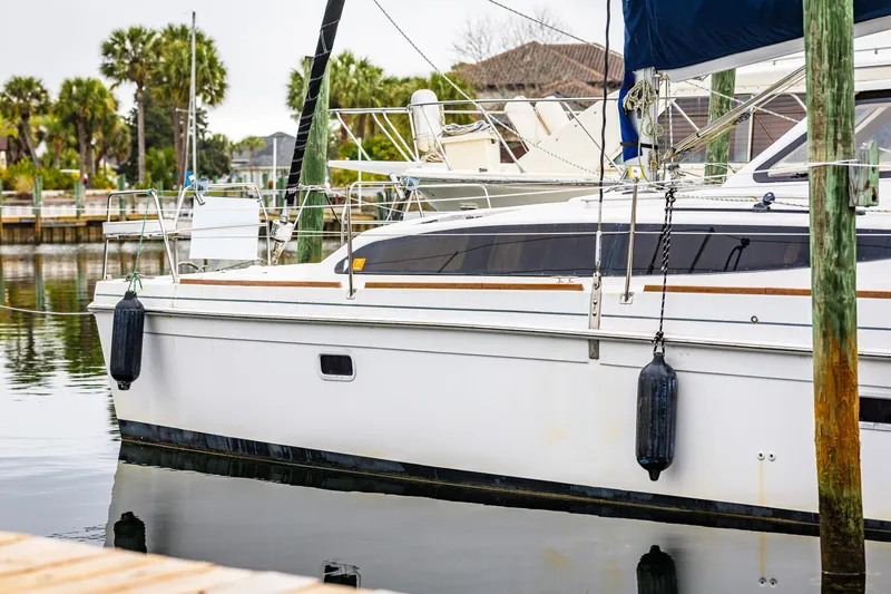 Slide: The Image of 2014 Gemini Legacy 35 catamaran docked in a serene marina setting. - 38