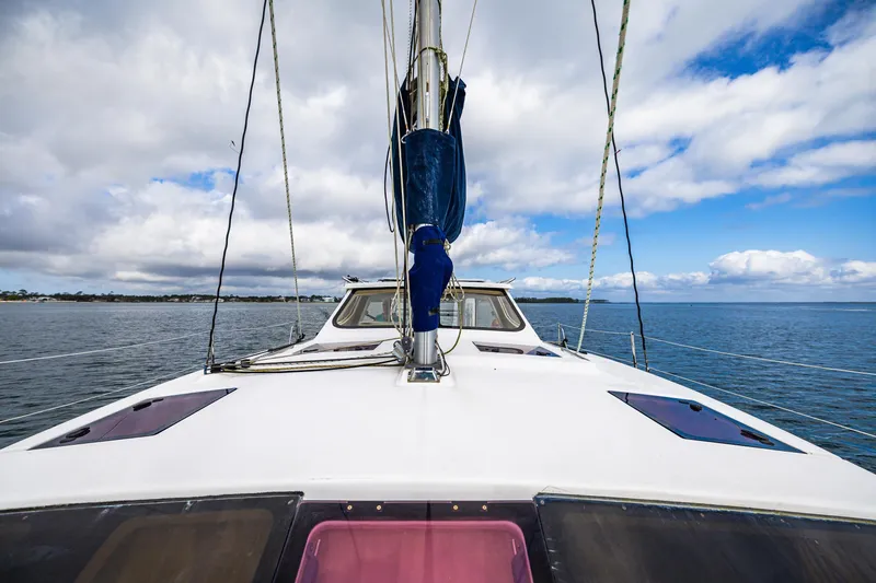 Slide: The Image of 2014 Gemini Legacy 35 sailboat on calm waters under a partly cloudy sky. - 9