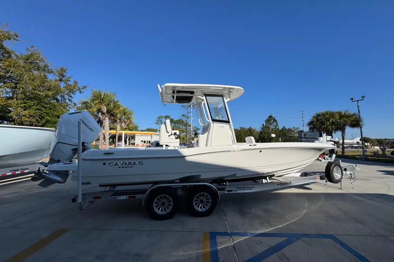 Slide: The Image of 2026 Caymas 26 HB boat on trailer under clear blue sky. - 10