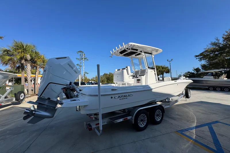 Slide: The Image of 2026 Caymas 26 HB boat on trailer, parked outdoors under clear blue sky. - 11