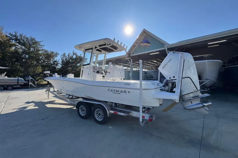 Slide: The Image of 2026 Caymas 26 HB boat on trailer, parked outdoors under clear blue sky. - 17