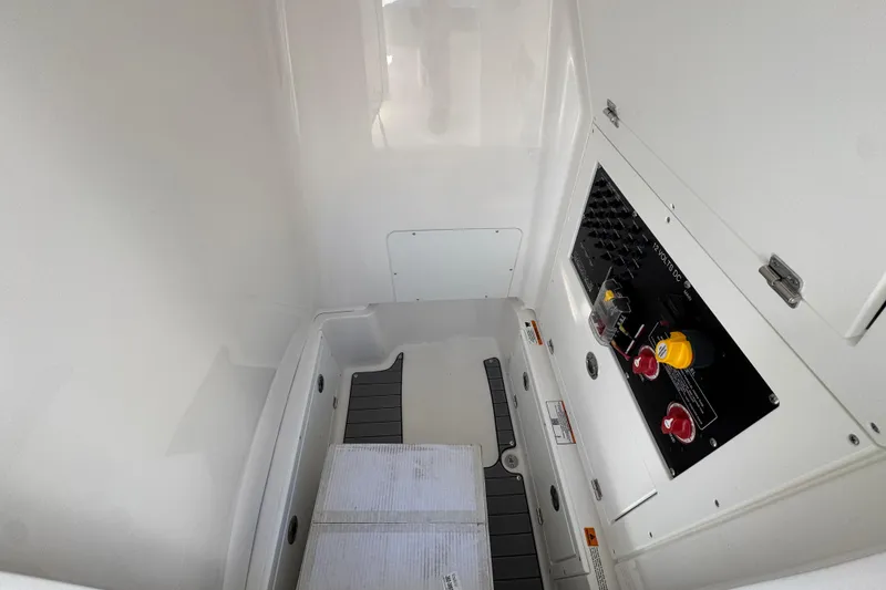 Slide: The Image of 2026 Caymas 26 HB boat interior with control panel and storage area. - 27
