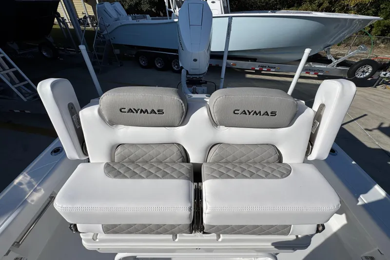Slide: The Image of 2026 Caymas 26 HB boat seats with gray and white upholstery, showcasing brand logo. - 30