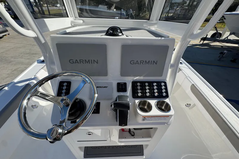 Slide: The Image of 2026 Caymas 26 HB boat dashboard with Garmin displays and Mercury controls. - 33