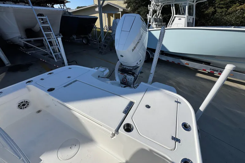 Slide: The Image of 2026 Caymas 26 HB boat with Mercury outboard engine in a marina setting. - 38