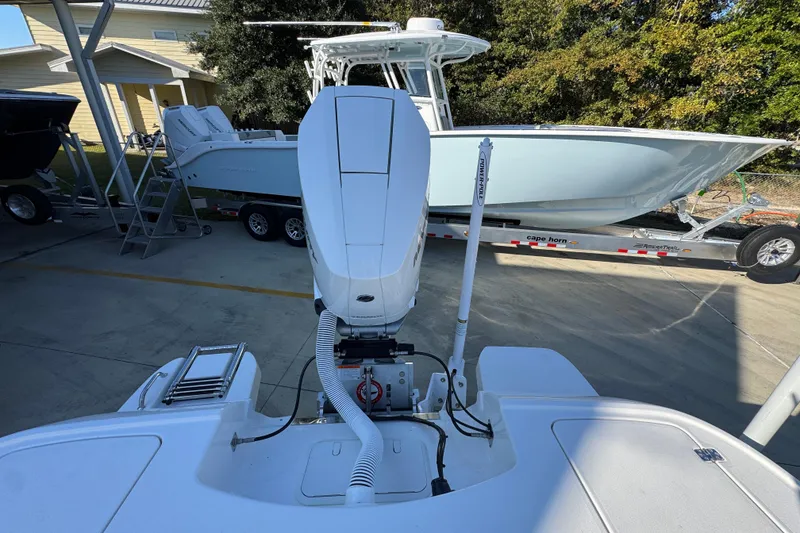 Slide: The Image of 2026 Caymas 26 HB boat on trailer, parked outdoors, with visible outboard motor. - 40