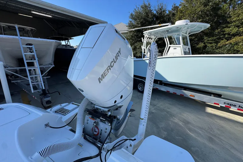 Slide: The Image of 2026 Caymas 26 HB boat with Mercury engine, parked on a trailer. - 41