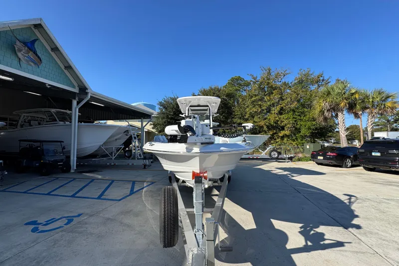 Slide: The Image of 2026 Caymas 26 HB boat on trailer in sunny outdoor storage area. - 6